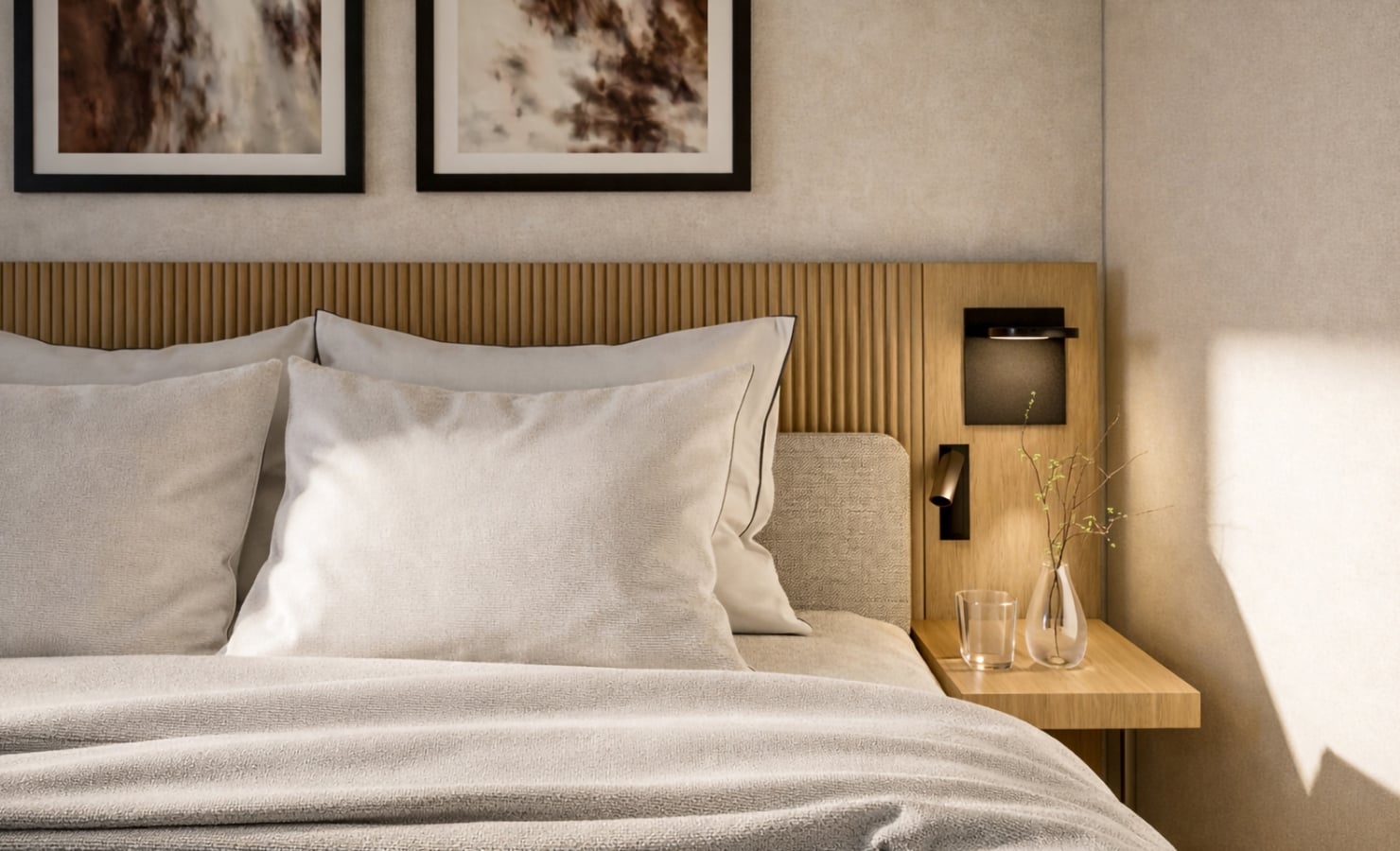 A neatly made bed with white pillows rests against a slatted wooden headboard, flanked by a modern bedside table with a vase and glass in a softly lit bedroom.