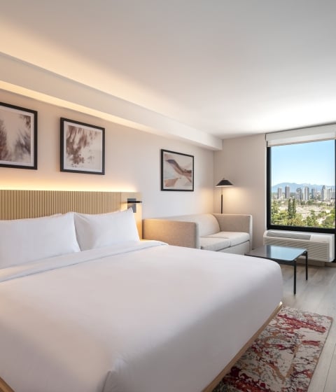 Hotel room with king size bed and mountain view